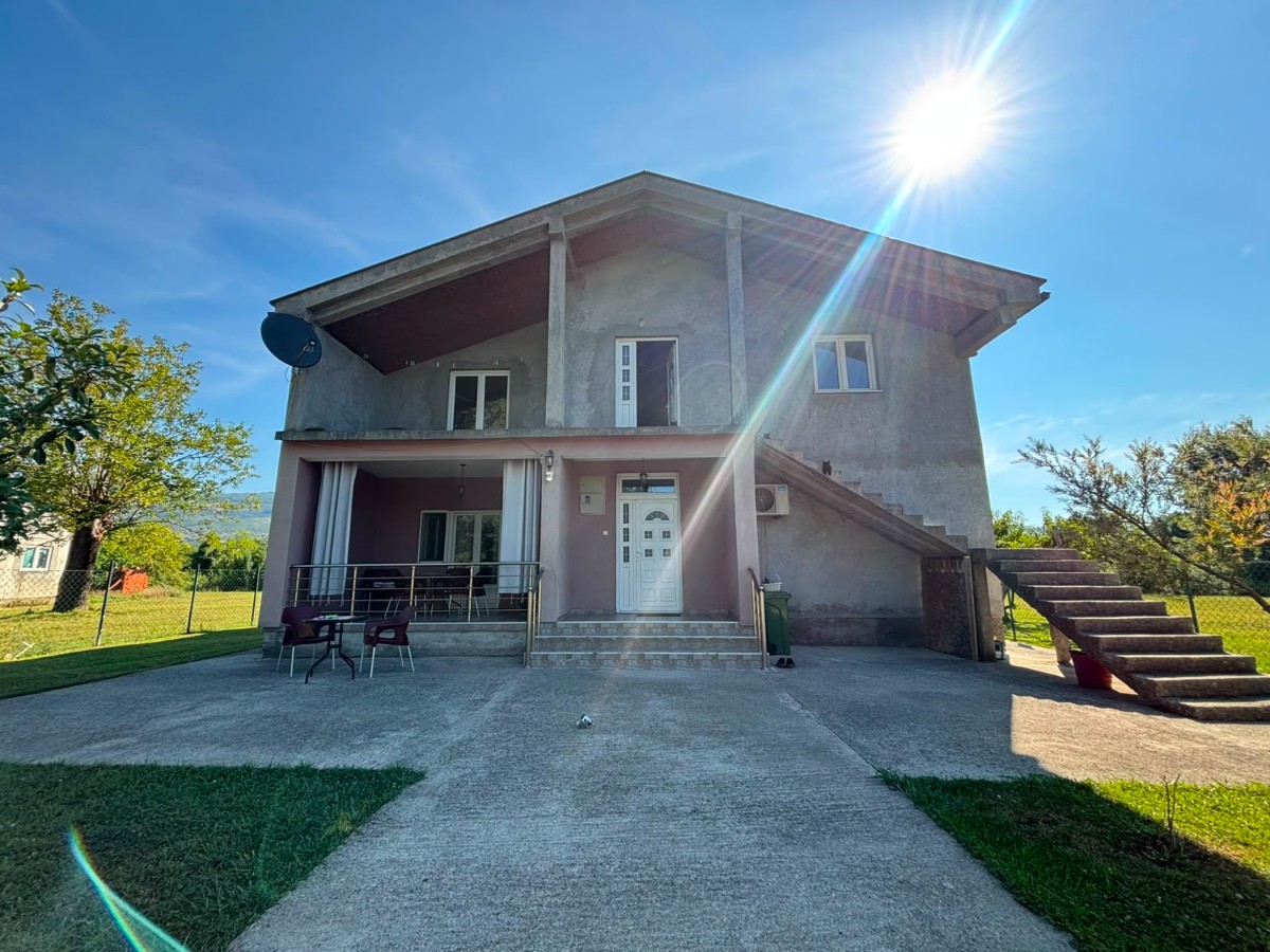 A two-story house with ancillary facilities and a larger plot of land is for sale in Kosić, Danilovgrad.