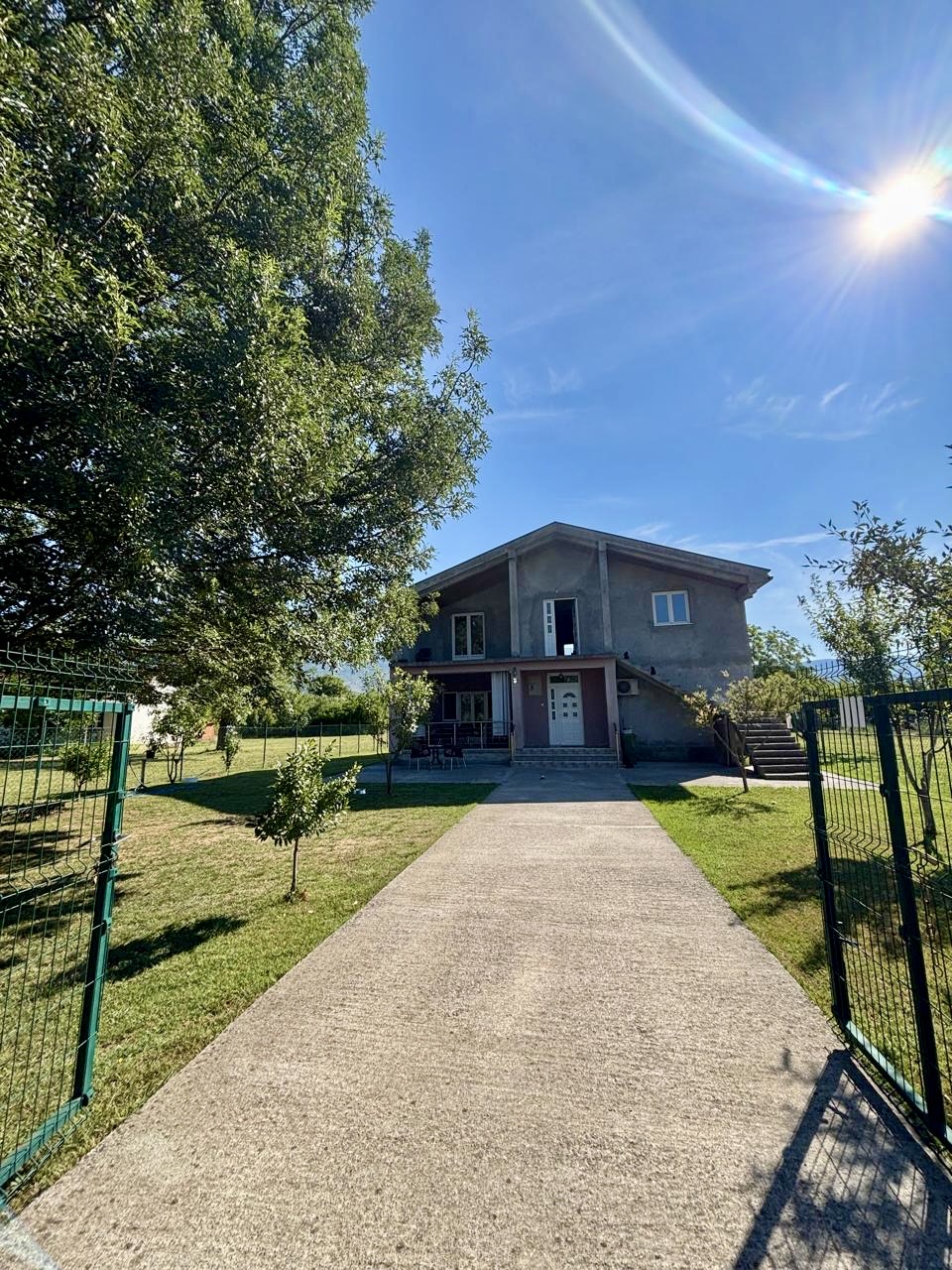 A two-story house with ancillary facilities and a larger plot of land is for sale in Kosić, Danilovgrad.